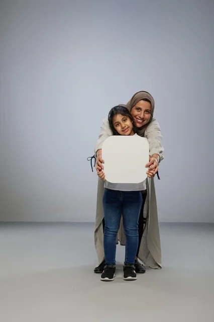 Saudi Mother and Daughter Holding Blank White Board
