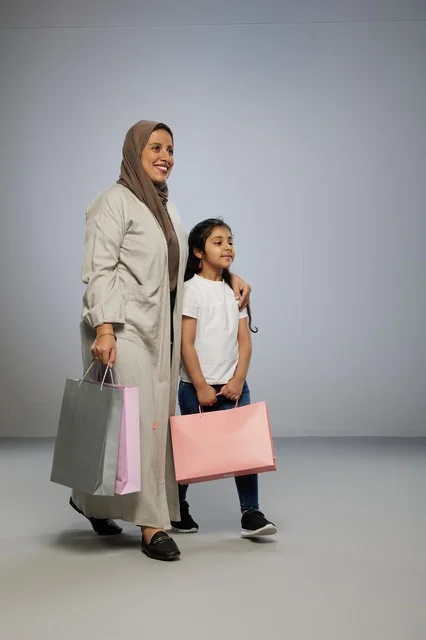 Saudi Mother and Daughter Carrying Shopping Bags