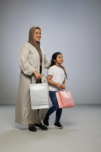 Saudi Mother and Daughter Carrying Shopping Bags