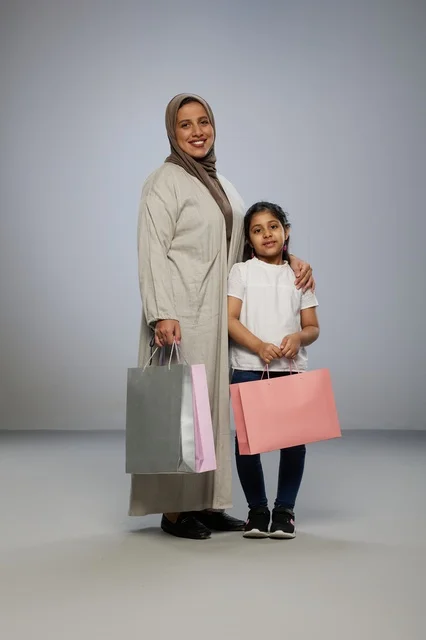 Saudi Mother and Daughter with Shopping Bags in Studio