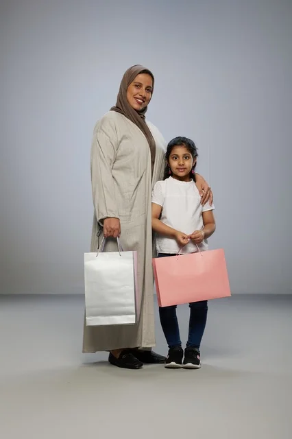 Saudi Mother and Daughter with Shopping Bags in Studio