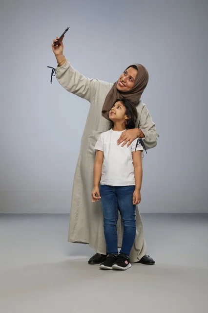 Saudi Mother and Daughter Taking Selfie in Studio Saudi Mother and Daughter Taking Selfie in Studio