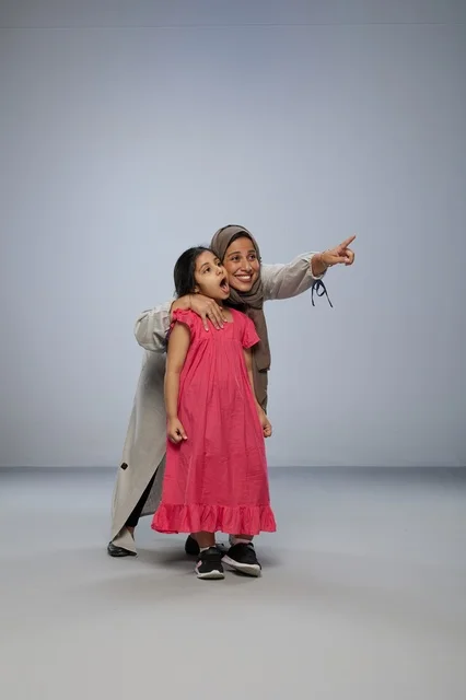 Saudi Mother and Daughter Pointing in Studio