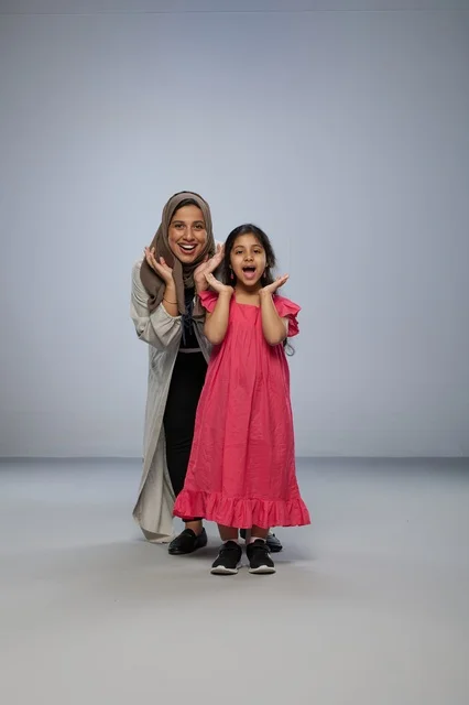 Saudi Mother and Daughter Surprised in Studio Portrait