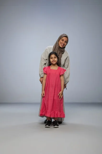 Saudi Mother and Daughter Smiling in Studio Portrait