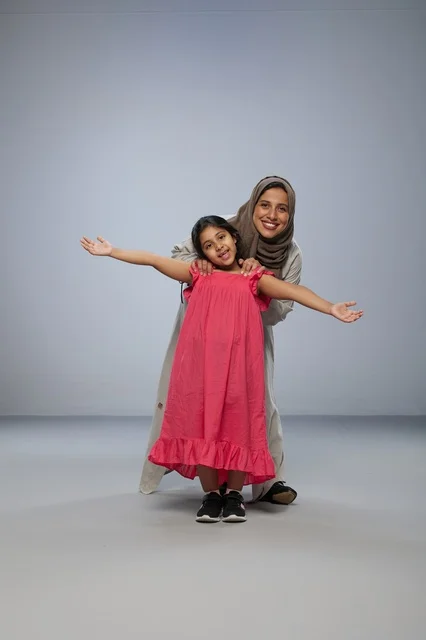 Saudi Mother and Daughter Smiling in Studio Portrait