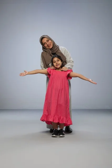 Saudi Mother and Daughter Smiling in Studio Portrait