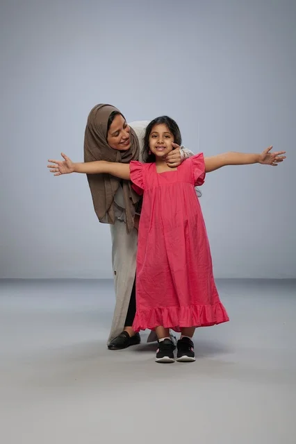 Saudi Mother and Daughter in Pink Dress in Studio