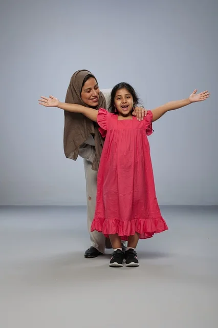 Saudi Mother and Daughter in Pink Dress Studio Portrait