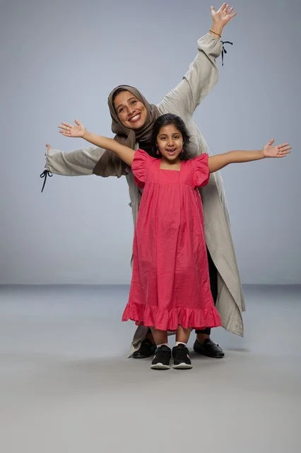 Smiling Saudi Mother and Daughter in Studio