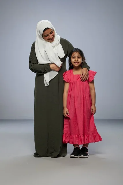 Saudi Mother and Daughter Standing in Studio Portrait