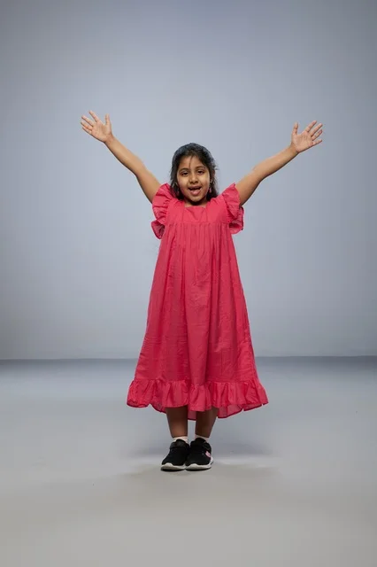 Saudi Girl in Pink Dress Jumping for Joy in Studio