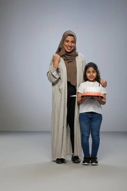 Saudi Mother and Daughter with Cake in Studio
