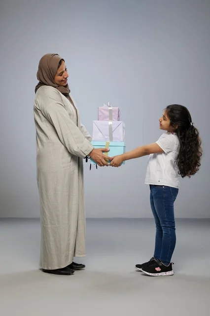 Arab Girl Giving Gift Boxes to Mother in Abaya