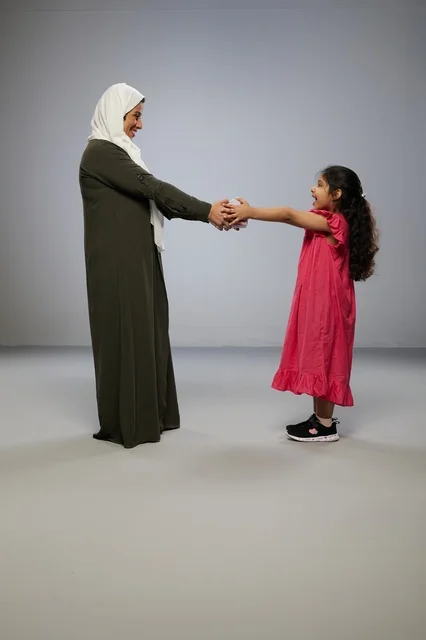 Arab Daughter Giving Gift Box to Mother in Studio Background