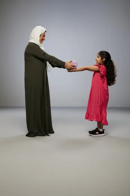 Arab Mother and Daughter with Gift in Studio