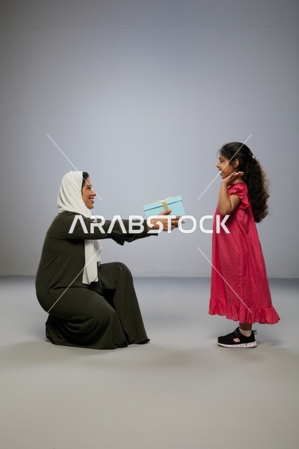 Arab Mother Receiving Gift Box from Daughter