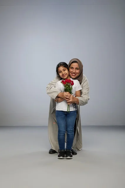 Arab Mother and Daughter with Red Roses in Studio
