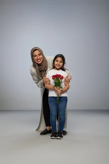Saudi Mother and Daughter with Red Rose Bouquet