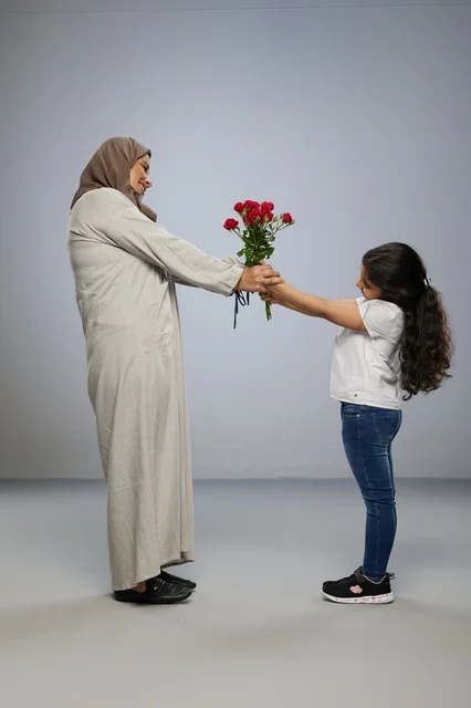 Arab Girl Giving Red Roses to Mother in Abaya
