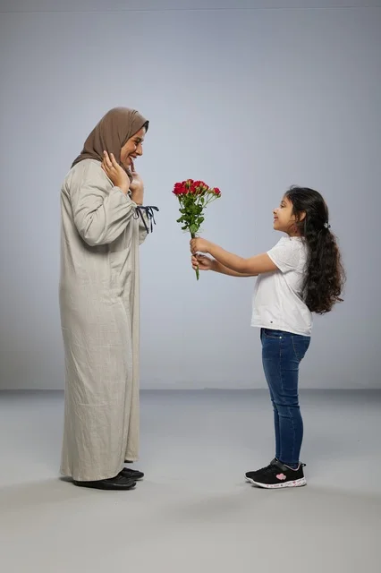Arab Girl Giving Red Roses to Mother in Studio Background