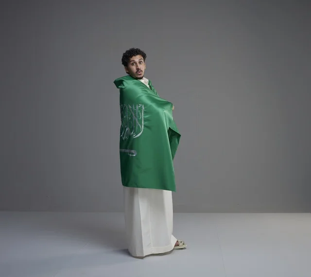 Saudi Man Wrapped in KSA Flag in Studio
