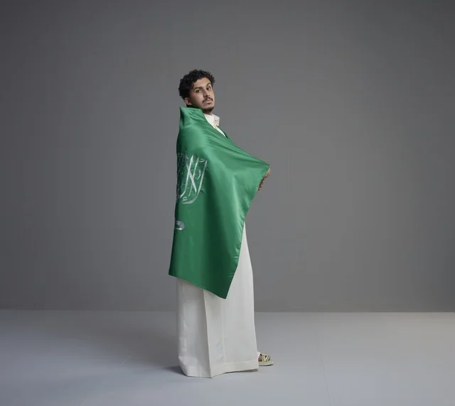 Saudi Man Wrapped in National Flag Studio Portrait