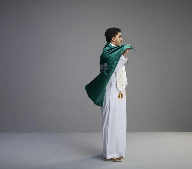 Smiling Saudi Man Holding National Flag