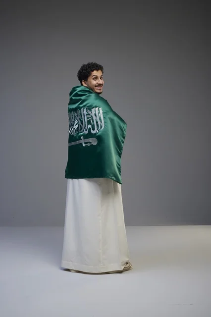 Saudi Man Wrapped in National Flag with White Thobe