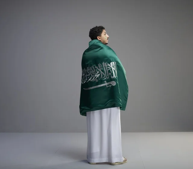 Saudi Man Wrapped in Saudi Arabia Flag in Studio