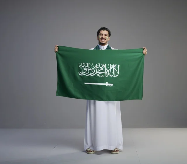 Saudi Man Holding National Flag in Studio Setting