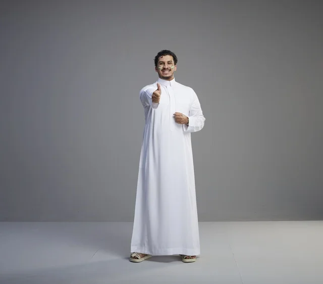 Saudi Man in Thobe Giving Thumbs Up for National Day