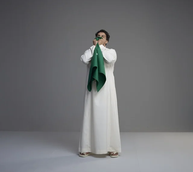 Saudi Man Kissing Saudi Arabia Flag in Studio