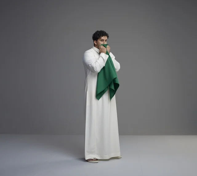 Saudi Man Kissing National Flag in Studio