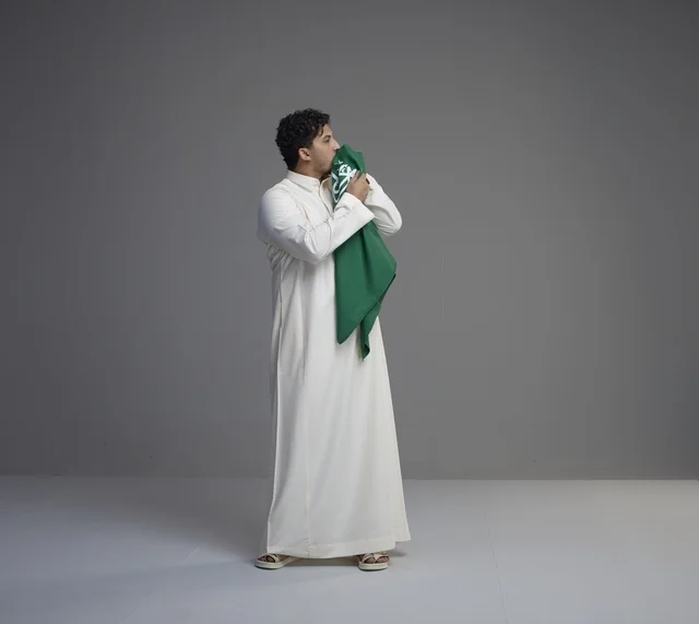Saudi Man Kissing National Flag in Studio