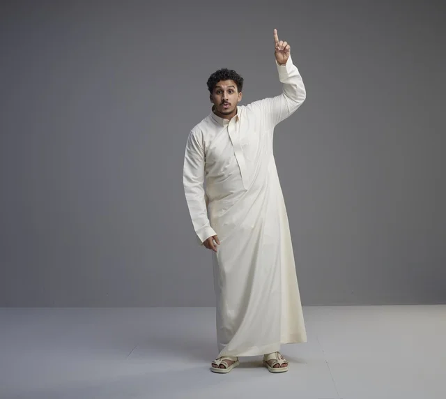 Saudi Man in White Thobe Pointing Upward
