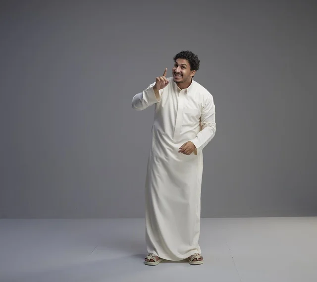 Saudi Man in White Thobe Pointing Upward