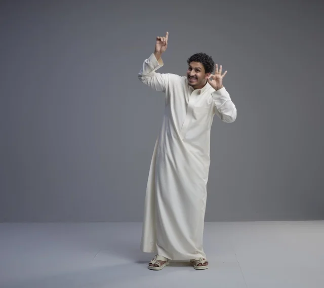 Saudi Man in White Thobe Making OK Gesture in Studio