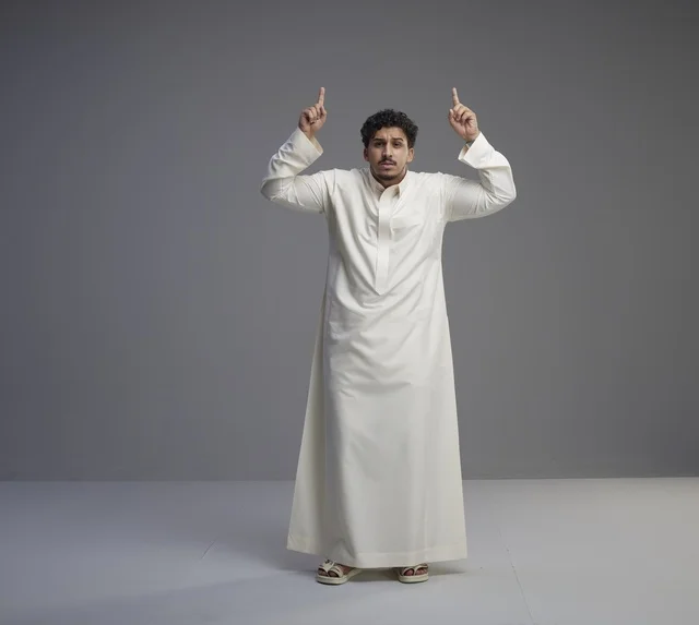 Saudi Man in White Thobe Pointing Upward
