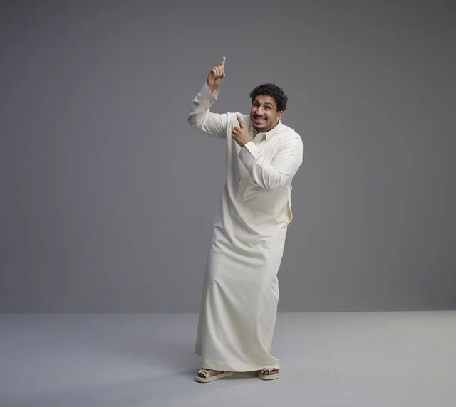 Saudi Man in White Thobe Pointing Upwards Studio