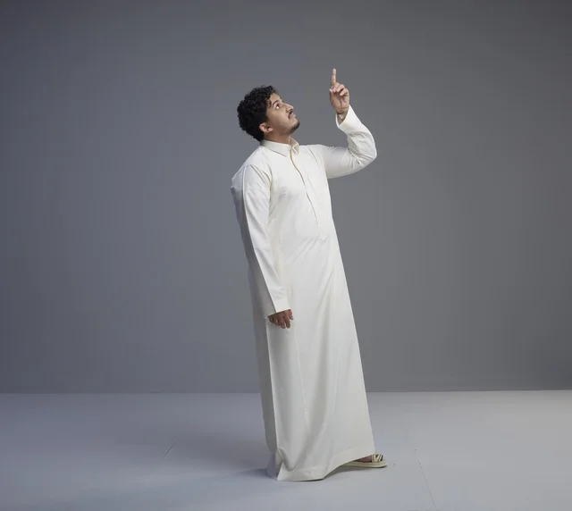 Saudi Man in White Thobe Pointing Upward