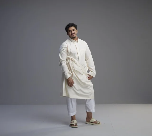 رجل سعودي بالثوب الأبيض التقليدي في الاستوديو