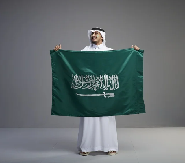 Saudi Man Proudly Holding the National Flag