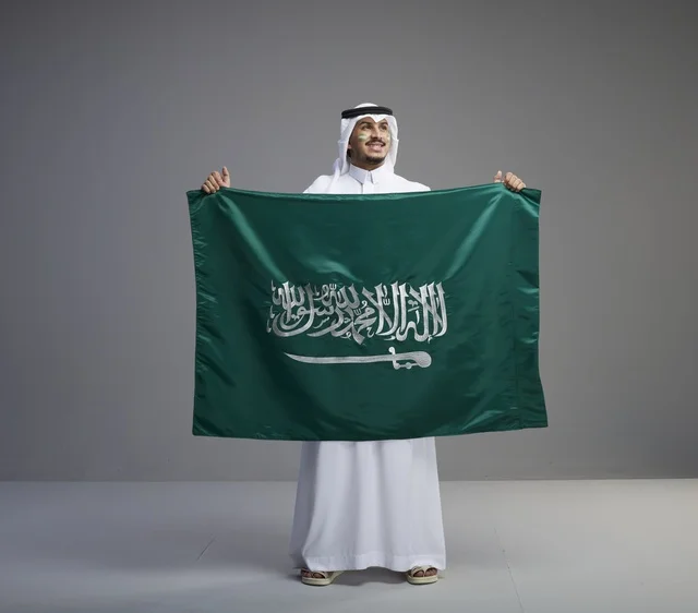 Saudi Man Proudly Holding the National Flag