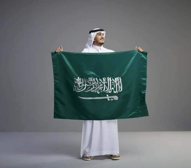 Saudi Man Proudly Holding the National Flag