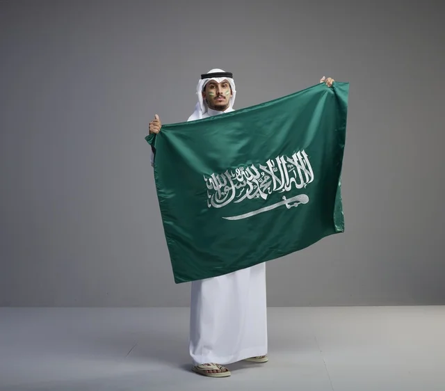 Saudi Man Proudly Holding the National Flag