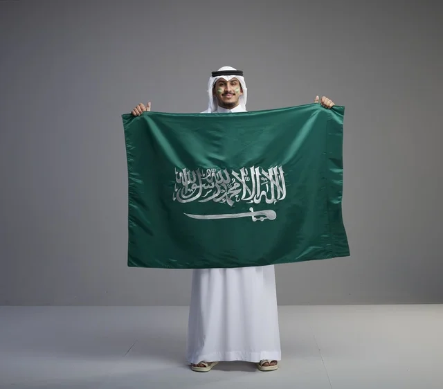 Saudi Man Proudly Holding the National Flag