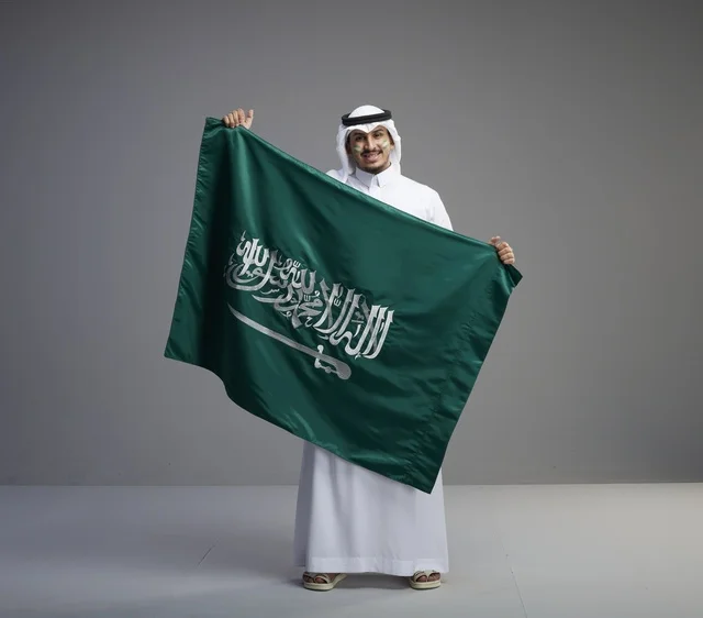 Saudi Man Proudly Holding the National Flag
