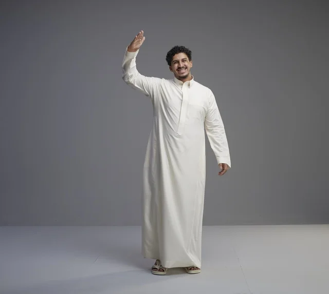 Saudi Man in Traditional White Thobe Waving in Studio