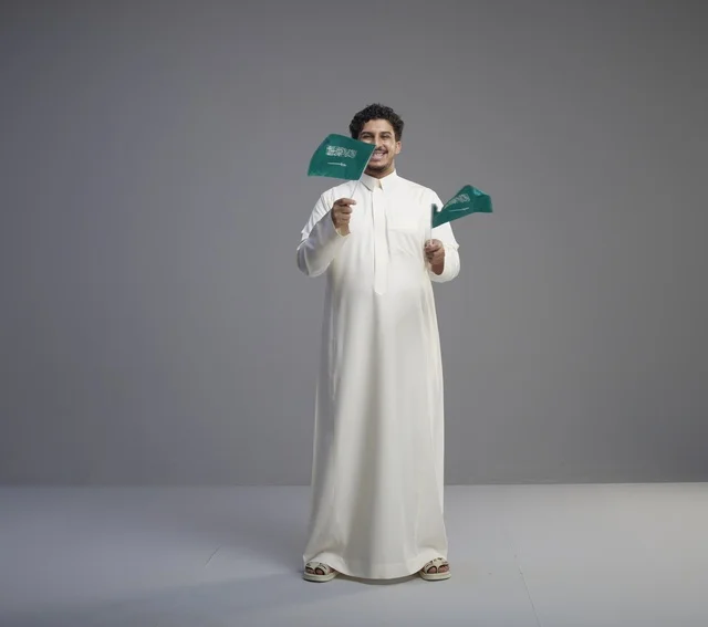 Smiling Saudi Man Waving Saudi Flag